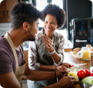 A young couple cook a healthy meal together at home.